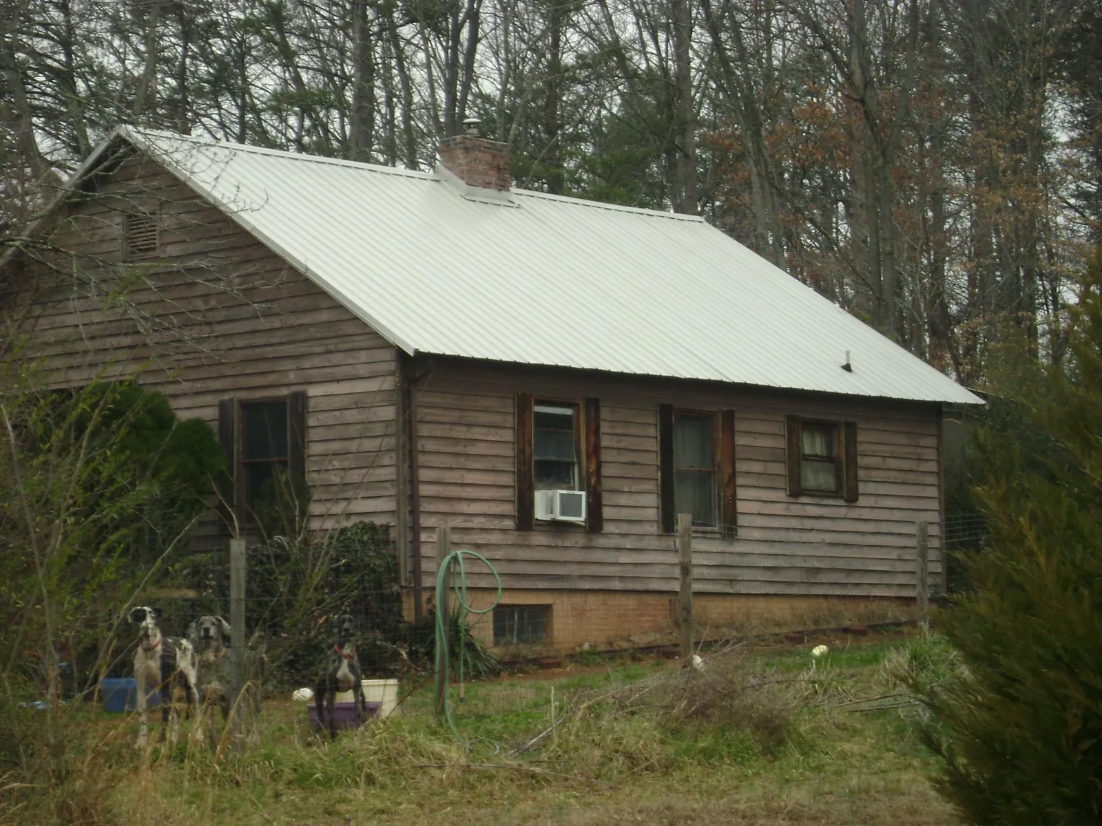 White metal roof on an old wood sided farmhouse, from a Metal Roof Installation job in Tipton