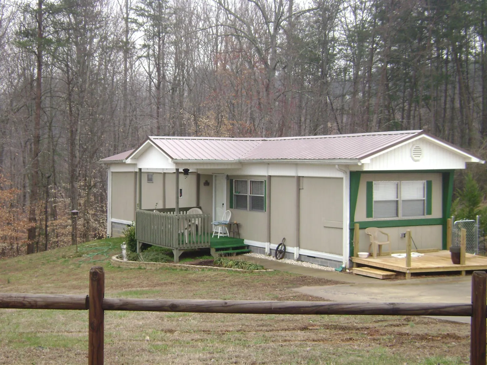 Mauve metal roof on a manufactured home with a new front deck in Tipton